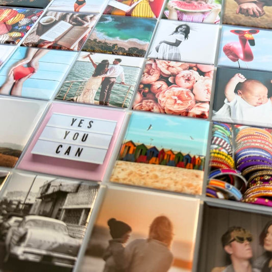 Image shows a flat lay of square photo magnets, displaying their vibrancy and quality.
