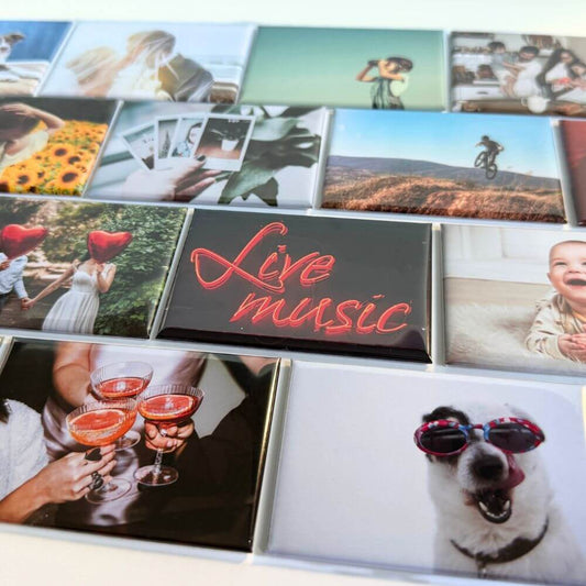 Image shows a flat lay of a variety of rectangle photo magnets