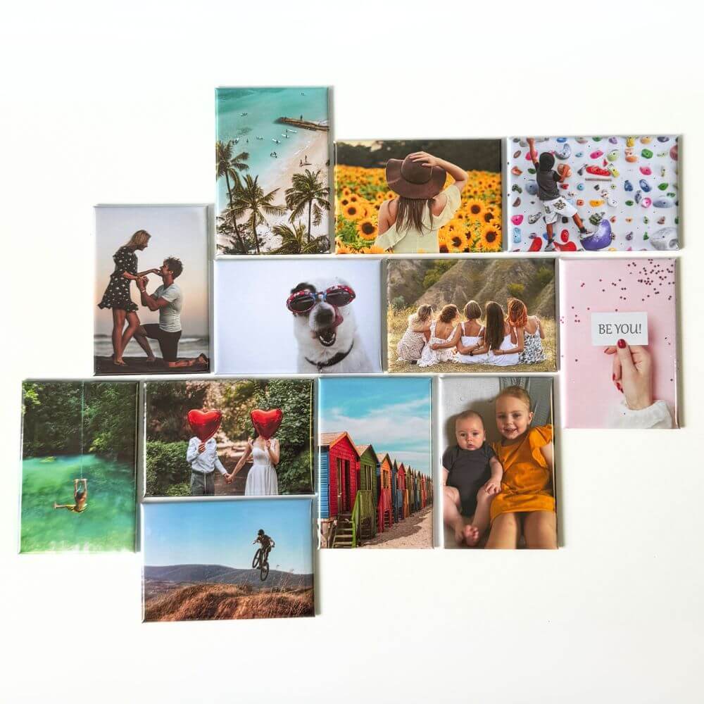 Image shows a flat lay of a set of 12 rectangle photo magnets. Demonstrating vibrancy and variety in what could be displayed on the magnets. 