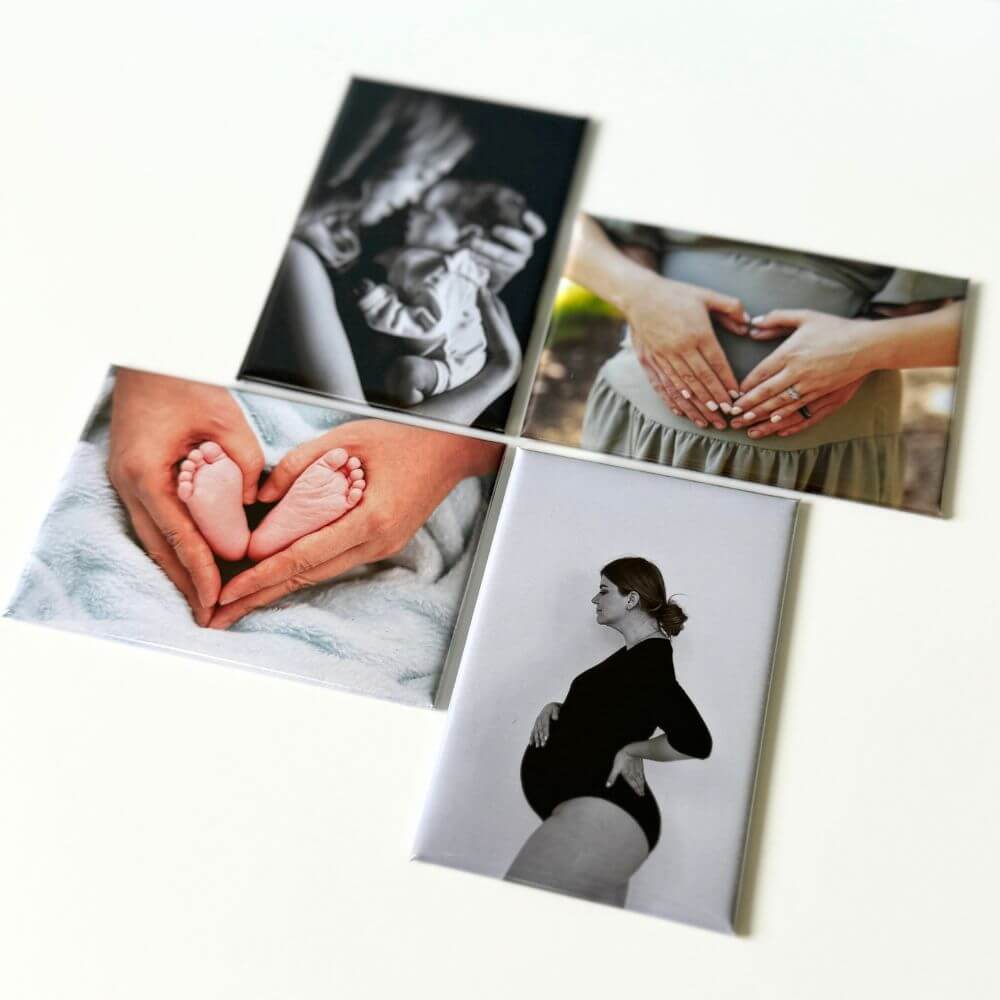Image shows a flat lay of four rectangle photo magnets with a variety of photos related to pregnancy and newborn.